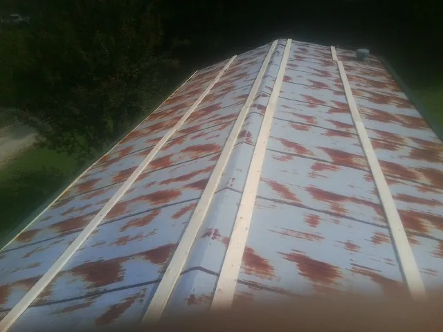 Rusted metal roof panels with new wood purlins before replacement — Storm Damage Roof Repair in Cayuga by Roofing Brothers